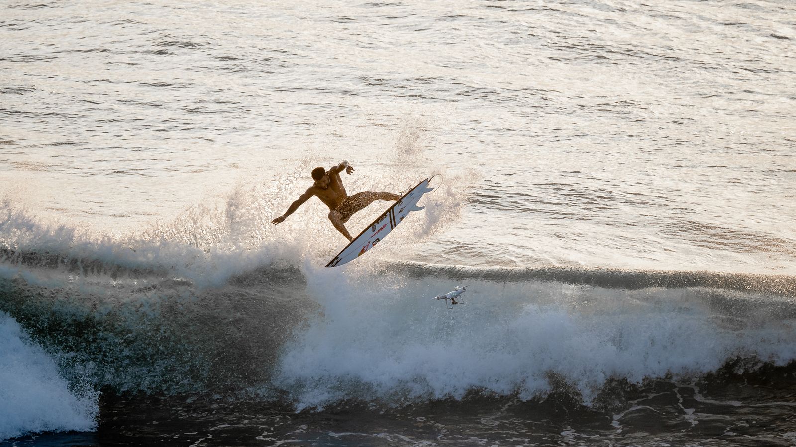 Surfer mid-air above a breaking wave
